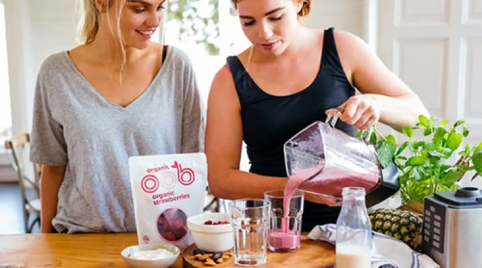 two women making smoothies with oob organic products