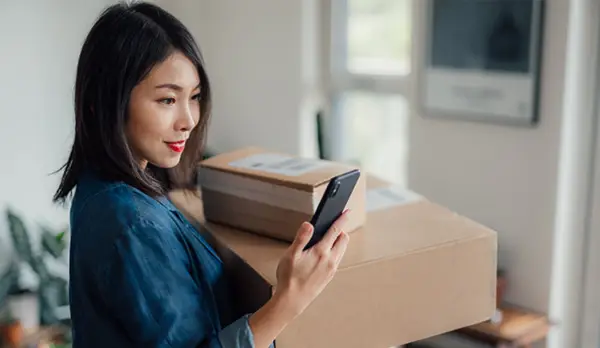 small business owner carrying boxes